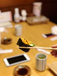 Person holding leaf in plate on table