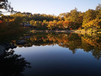 Scenic view of lake by trees against sky during autumn