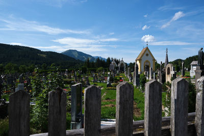 Panoramic view of cemetery and buildings against sky