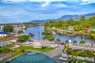 High angle view of lake by city against sky