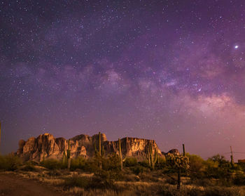 Scenic view of rock formation against sky at night