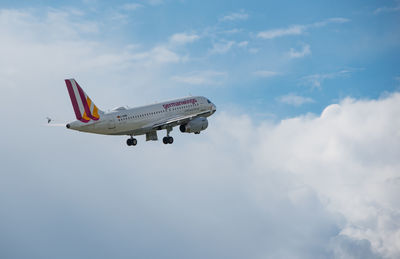 Low angle view of airplane flying against sky