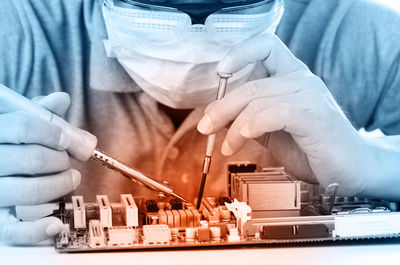 Close-up of engineer repairing circuit board