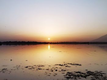 Scenic view of sea against clear sky during sunset