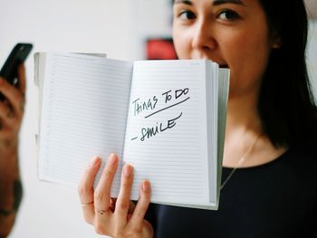 Cropped image of woman holding book