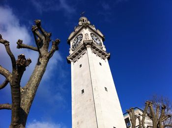 Low angle view of tower against blue sky