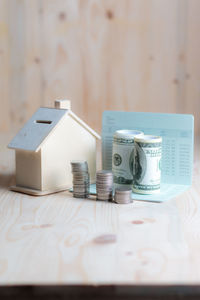 Close-up of model home with money on table