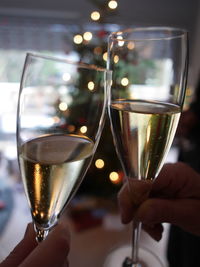 Close-up of two hands holding glass of wine 