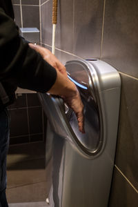 Low section of man drying hands 