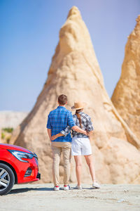 Rear view of man standing on rock