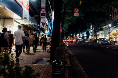 People on city street at night