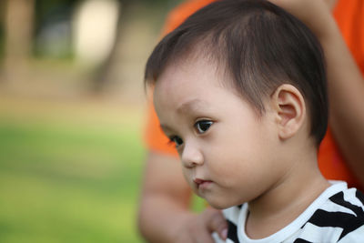 Close-up of cute boy looking away