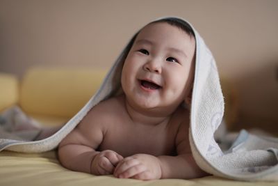 Portrait of cute baby covered with towel
