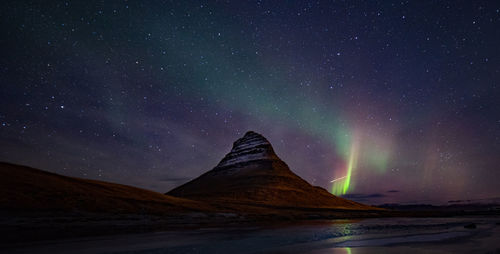 Scenic view of lake against sky at night