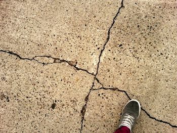 Low section of woman standing on tiled floor