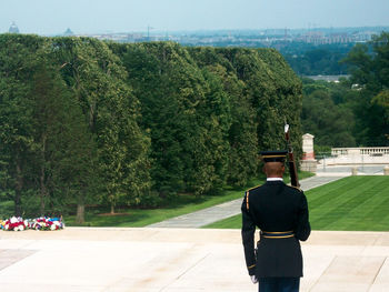 Rear view of man photographing against sky