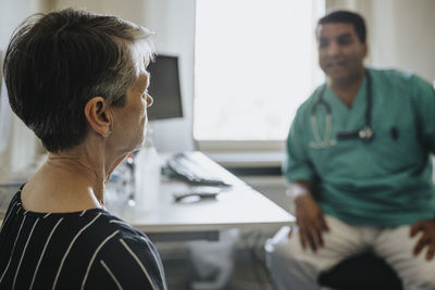 Senior woman visiting male doctor in hospital