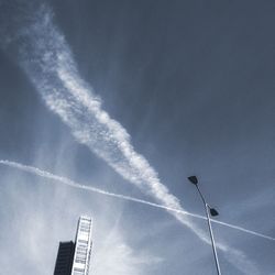 Low angle view of airplane flying against sky