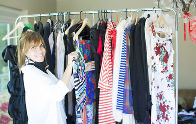 Midsection of woman standing in rack at store