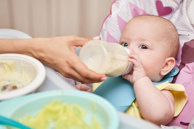 Portrait of cute baby girl eating food