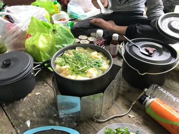 Low section of man preparing food at campsite