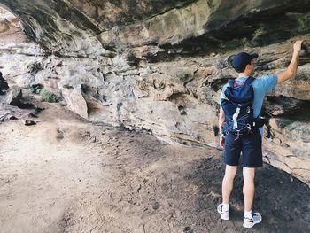 Rear view of man standing on rock