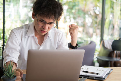 Thoughtful businessman working at desk in office