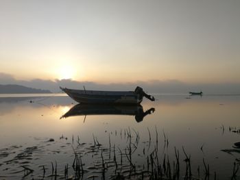 Scenic view of lake against sky during sunset