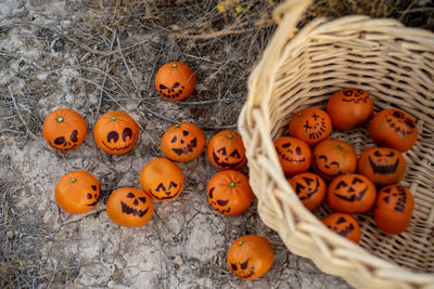 Healthy trick or treat snacks for kids on halloween--basket of mandarin oranges jack o lantern faces