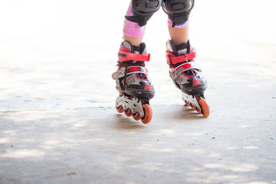 Low section of child skating on road