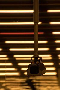 Close-up of illuminated lighting equipment hanging on wall