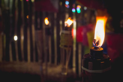 Close-up of lit candles in the dark