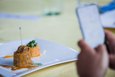 Close-up of man preparing food on table