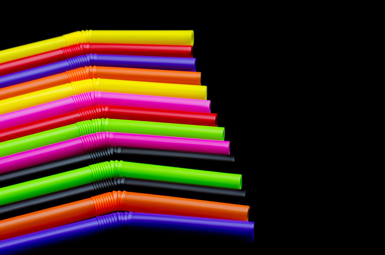 HIGH ANGLE VIEW OF MULTI COLORED PENCILS IN BLACK BACKGROUND
