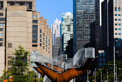 Modern buildings in city against sky