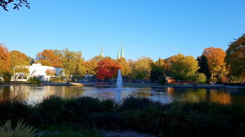 Scenic view of lake against clear sky during autumn