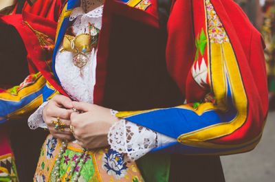 Midsection of couple holding hands