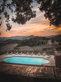 Scenic view of swimming pool against sky during sunset