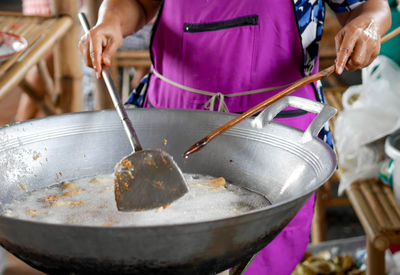 Midsection of person preparing food in market