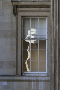 Reflection of building on glass window