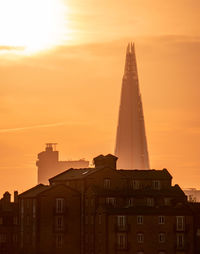 Low angle view of buildings against sky during sunset