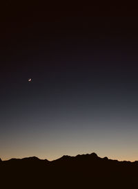 Scenic view of silhouette moon against clear sky at night