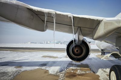 Airplane on runway against sky