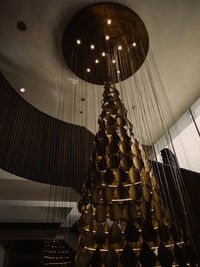 Low angle view of illuminated lights hanging on ceiling in building