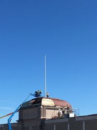 Low angle view of building against blue sky