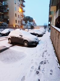 Car on snow covered street in city