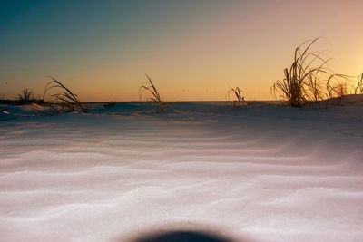 Scenic view of frozen sea against clear sky during sunset