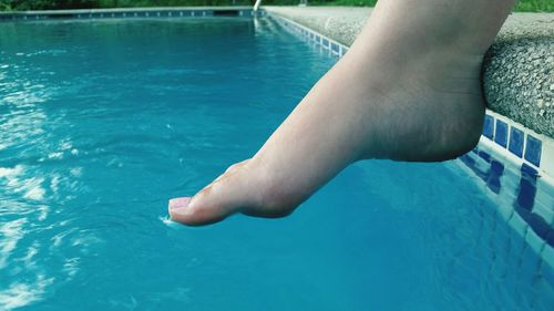 Low section of woman at poolside