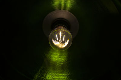 Low angle view of illuminated light bulb