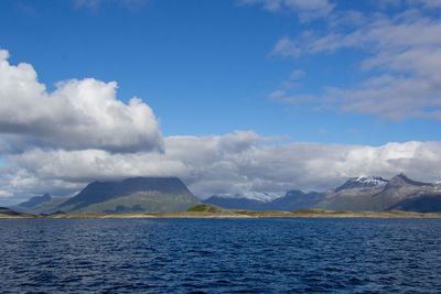 Scenic view of sea and mountains against sky